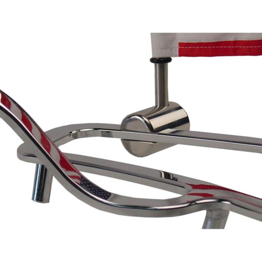 Close-up of a chrome motorcycle luggage rack with a flag mounting pole and American flag.
