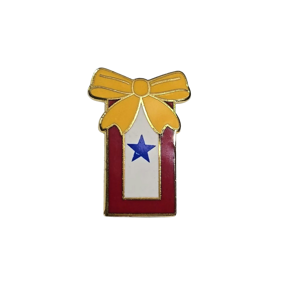 In service pin with a yellow bow, red box, and blue star on a white background