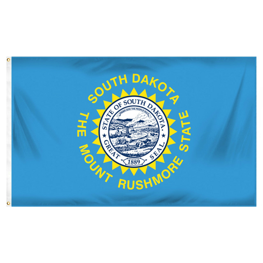 State of South Dakota state flag featuring the full-color state seal, gold sunburst, and 'South Dakota, The Mount Rushmore State' text on a solid sky-blue field