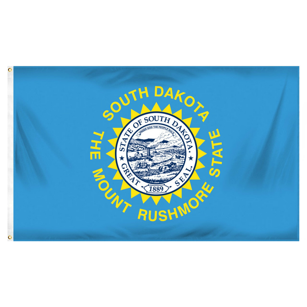 State of South Dakota state flag featuring the full-color state seal, gold sunburst, and 'South Dakota, The Mount Rushmore State' text on a solid sky-blue field