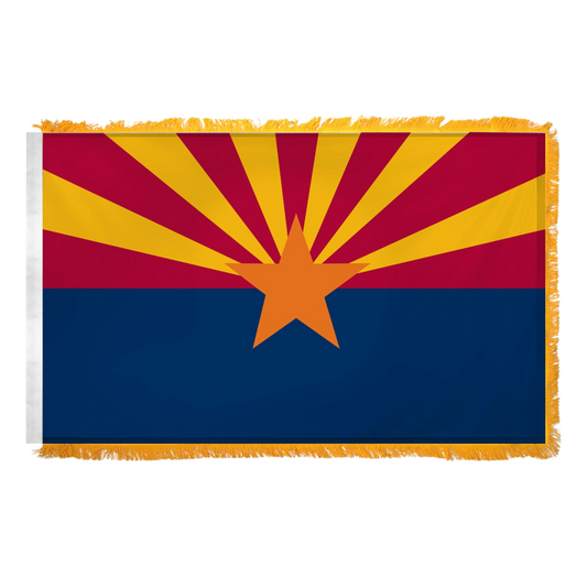 State of Arizona flag with a blue bottom half and red top flag with an orange star in the middle and 6 yellow stripes emanating from the star on the red top half.  Flag has yellow fringe.