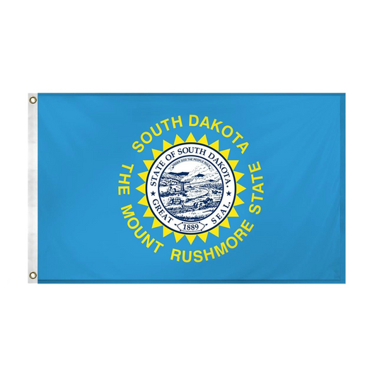 State of South Dakota state flag featuring the full-color state seal, gold sunburst, and 'South Dakota, The Mount Rushmore State' text on a solid sky-blue field