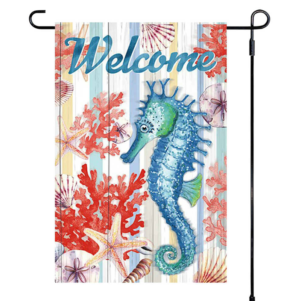 Decorative garden flag with a seahorse, coral, and starfish design on a striped background with the word 'Welcome'.
