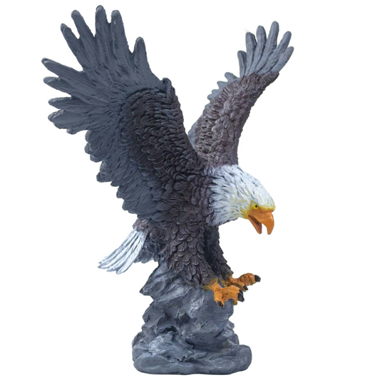Statue of a bald eagle with outstretched wings on a white background