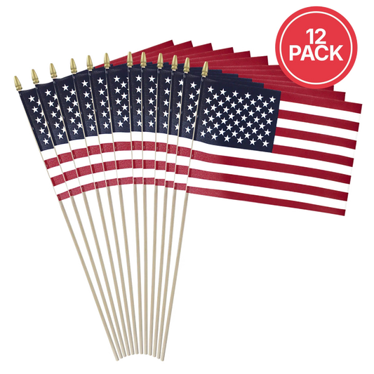 A 12-pack of small American flag stick flags with wooden sticks and gold spear tips, arranged in a fan shape on a white background with a red circular '12 PACK' badge in the top right.