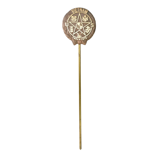 Bronze Vietnam Service Medal grave marker on a stick against a white background