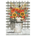 Decorative fall-themed garden banner with an arrangement with flowers, pumpkins, and a checkered bow in a metal bucket on a striped background.