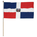 Flag of the Dominican Republic with a coat of arms in the center of a horizontal white strip intersecting a vertical white stripe and two blue corners and two red corners.