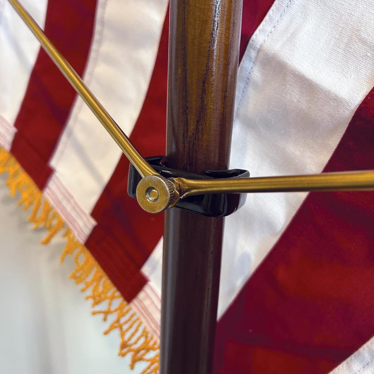 Close up of a gold spreader for an American flag installed