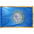 State of South Dakota state flag featuring the full-color state seal, gold sunburst, and 'South Dakota, The Mount Rushmore State' text on a solid sky-blue field.  Flag has fringe the edges.
