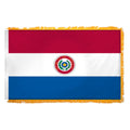 A Paraguay flag with horizontal stripes of red and white, and a blue lower section, featuring emblem.  Flag has yellow fringe.