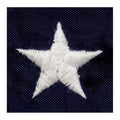 Close up of a white embroidered star on the blue canton of an American flag