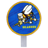 Circular U.S. Navy Seabees grave marker attached to a metal stake, featuring the classic fighting bee logo on a blue background.