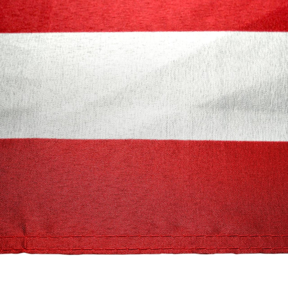 Close up of a white stripe and two red stripes from an American flag on a white background