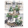 Decorative flag featuring two-tiered wooden stand with decorative items including a snowman, trees, and checkered elements against a window background.