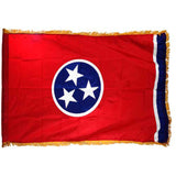 Tennessee state flag with a red background, blue circle with white stars, and gold fringe on a white background