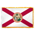 State of Florida flag featuring the classic red diagonal cross on a white background with the full-color Florida state seal in the center.  The words 'GREAT SEAL OF THE STATE OF FLORIDA' and 'IN GOD WE TRUST' are written on the edges of the seal.  This flag features yellow fringe.