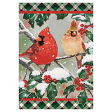 Decorative flag with two cardinals on a branch surrounded by holly leaves and berries.