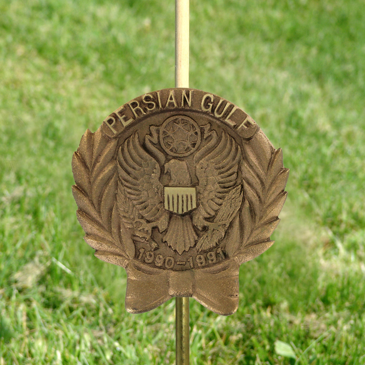 Bronze Persian Gulf War memorial grave marker on a grassy background