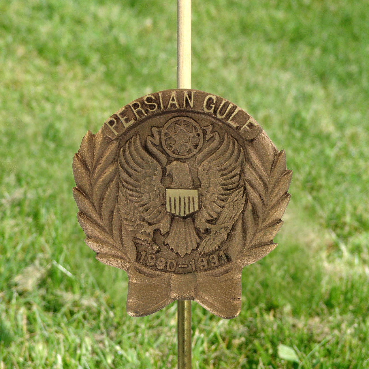 Bronze Persian Gulf War memorial grave marker on a grassy background