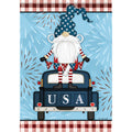 Decorative flag with a Gnome in an American flag hat sitting in a truck with 'USA' on the back, against a blue background with fireworks.