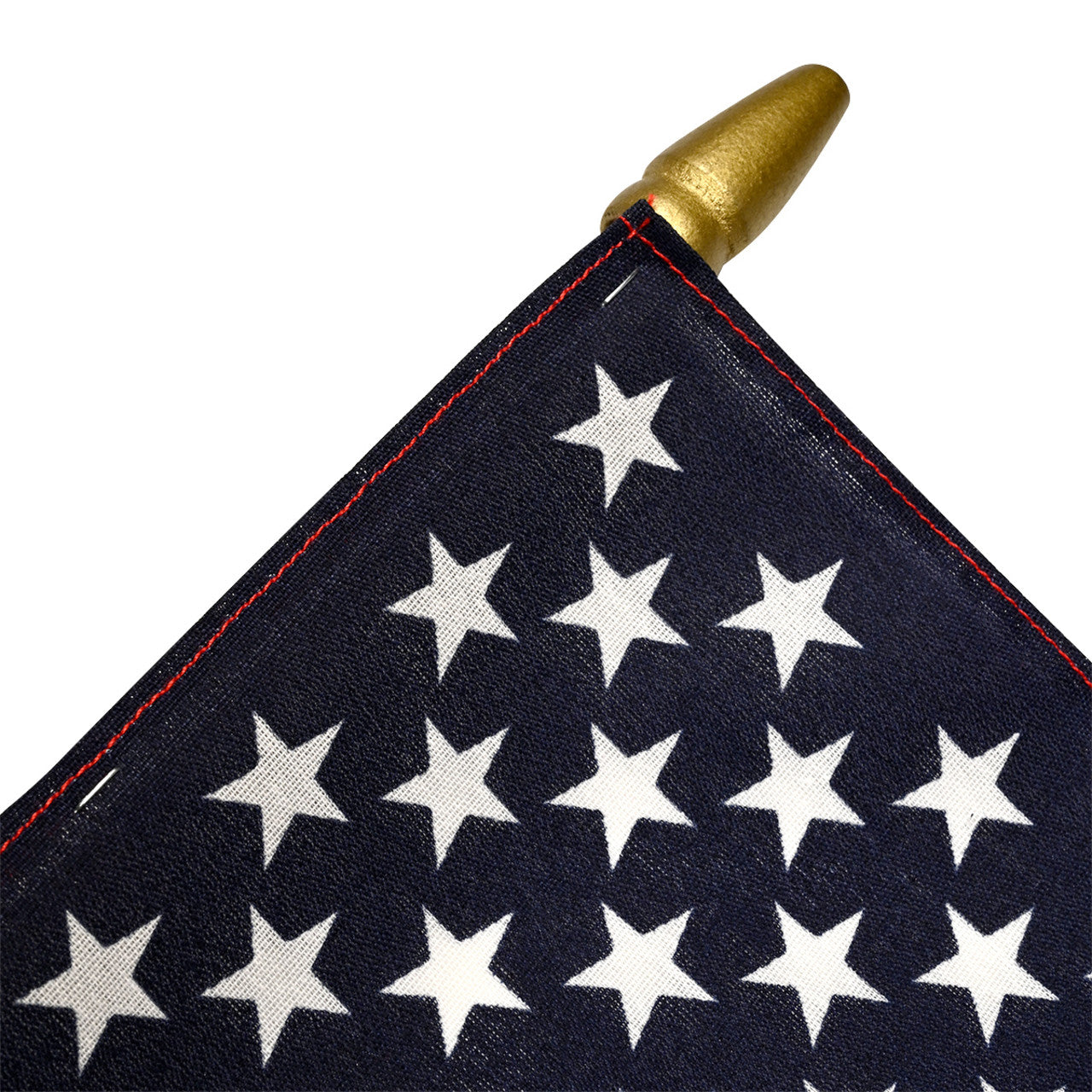 Close-up of an American flag with white stars on a blue background, featuring a gold spearhead.