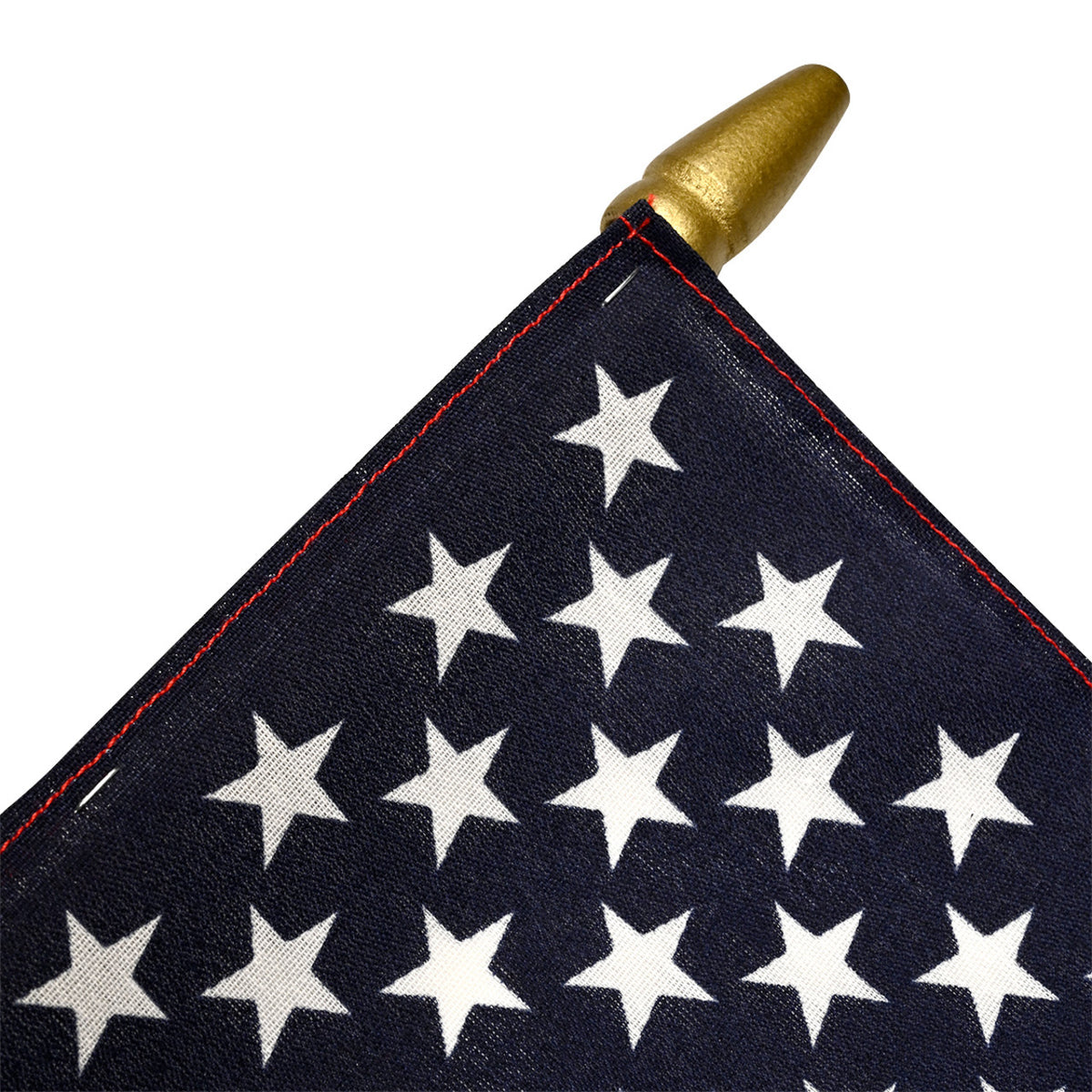 Close-up of an American flag with white stars on a blue background, featuring a gold spearhead.