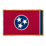 Tennessee state flag with a blue circle featuring three white stars on a red background