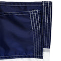 Close up of blue fabric from a flag with white stitching