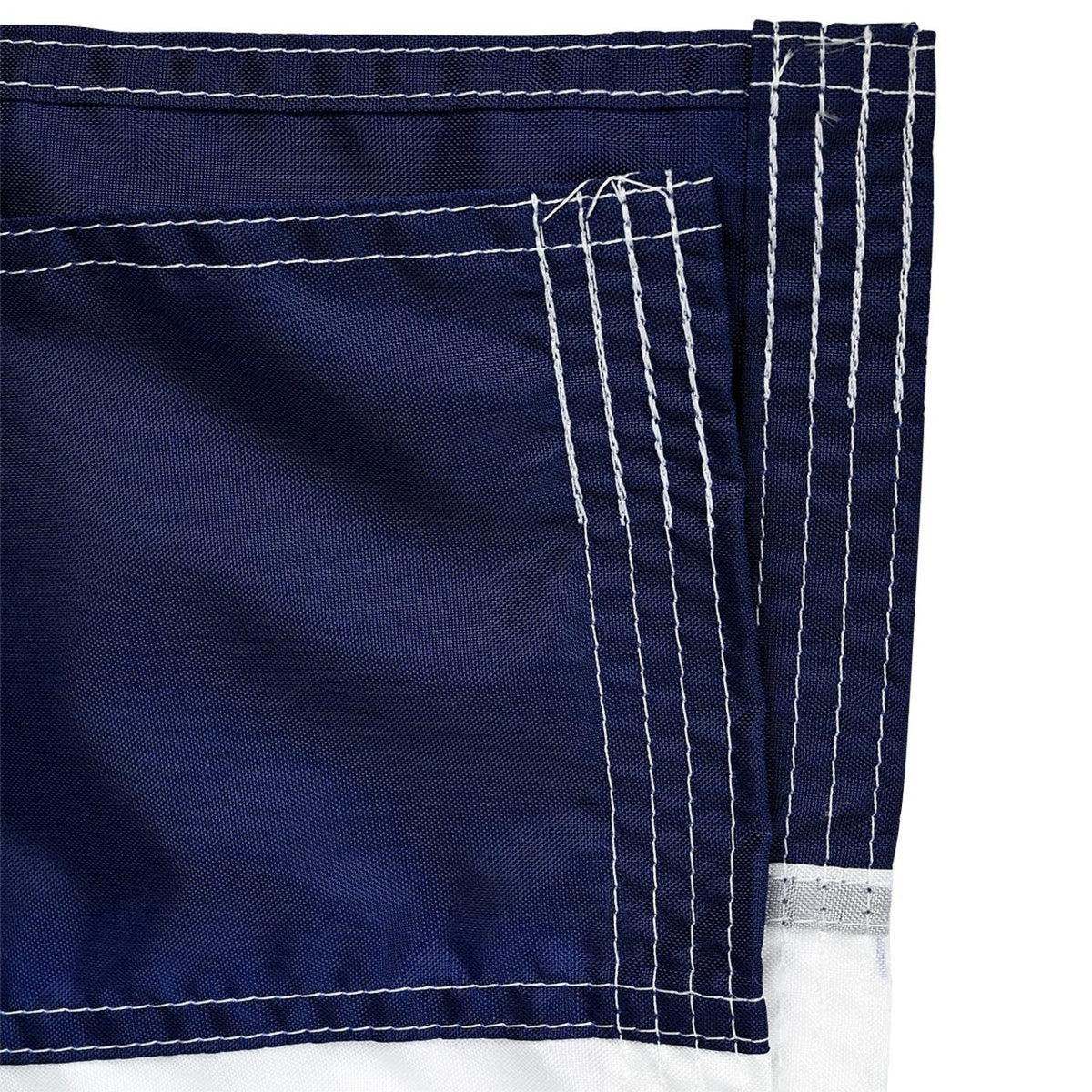 Close up of blue fabric from a flag with white stitching