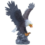 Statue of a bald eagle with outstretched wings on a white background