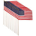 Row of American flags on sticks against a white background
