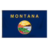 State of Montana flag with 'MONTANA' printed in large, gold all-caps letters across the top. Centered below the text is the full-color state seal, depicting a landscape with the Rocky Mountains, the Great Falls of the Missouri River, a plow, a shovel, and a pick. A ribbon at the bottom of the seal reads the Spanish motto 'ORO Y PLATA'.