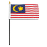 Malaysian flag on a stick with a white background