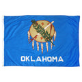 State of Oklahoma flag featuring the traditional buffalo-skin shield, peace pipe, olive branch, and white 'Oklahoma' text on a vibrant sky-blue field.
