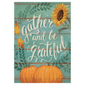 Decorative garden flag with 'Gather and be Grateful' text, sunflower, and pumpkins on a teal background.