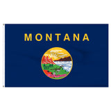 State of Montana flag with 'MONTANA' printed in large, gold all-caps letters across the top. Centered below the text is the full-color state seal, depicting a landscape with the Rocky Mountains, the Great Falls of the Missouri River, a plow, a shovel, and a pick. A ribbon at the bottom of the seal reads the Spanish motto 'ORO Y PLATA'