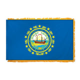 State of New Hampshire flag featuring the full-color state seal with the frigate Raleigh, a laurel wreath, and 'Seal of the State of New Hampshire 1776' text on a solid dark blue field.  This flag features yellow fringe.
